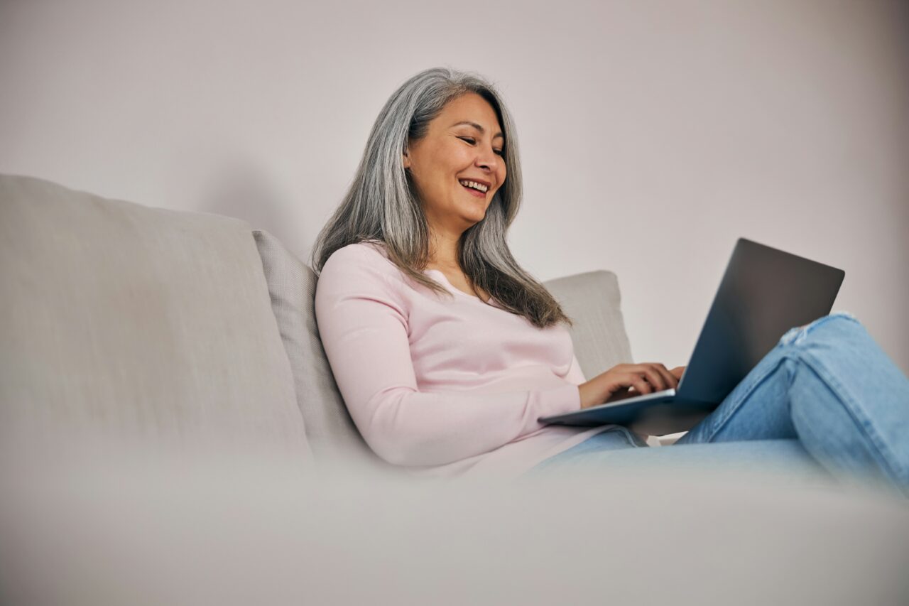 Woman at home using laptop for online therapy